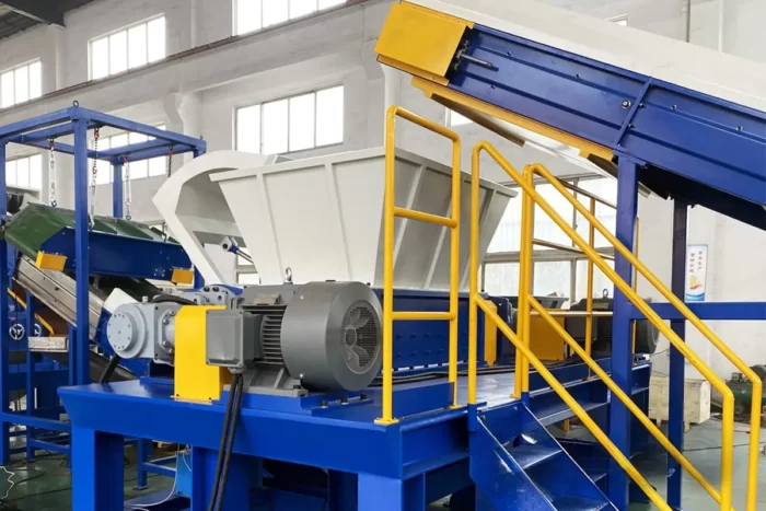 a double shaft shredder, a powerful industrial machine used primarily for the size reduction of a variety of materials, including plastics, metals, and paper. This type of shredder is characterized by its two rotating shafts, which are equipped with cutting blades that efficiently break down materials into smaller pieces.