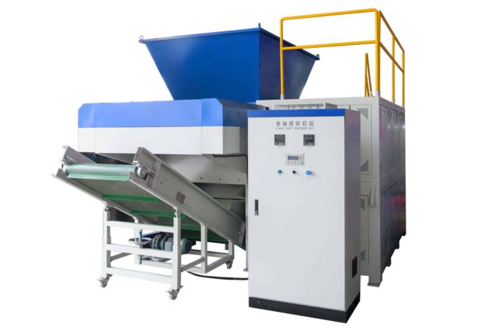 Industrial single shaft plastic shredder machine with large blue hopper, integrated control panel, and conveyor belt system on a white background.
