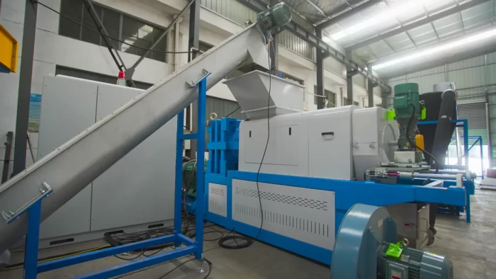 a Squeezing Machine used primarily in the plastic recycling process. This specific type of equipment is crucial for mechanically dewatering or drying washed plastic flakes or films. By squeezing out moisture, the machine significantly reduces the drying time and energy consumption required before the plastic can be further processed into pellets.