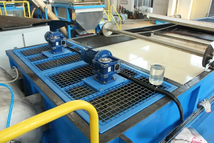 a Dissolved Air Flotation (DAF) unit, a technology widely used in water treatment processes, especially in industrial settings. This unit is crucial for removing suspended solids, oils, and other contaminants from wastewater. The DAF system operates by dissolving air under pressure and then releasing it at atmospheric pressure in a flotation tank basin. The released air forms tiny bubbles that attach to the contaminants causing them to float to the surface from where they can be removed. In the image, you can see the flotation tank filled with water, and multiple blue motorized units that likely drive the system’s pumps or air compressors. This equipment is essential in settings where water purity is critical, such as in recycling facilities for cleaning process water or in industries that discharge wastewater and must meet environmental regulations. The blue and yellow coloration of the equipment enhances visibility and safety, while the mesh guards protect the moving parts and the operators.