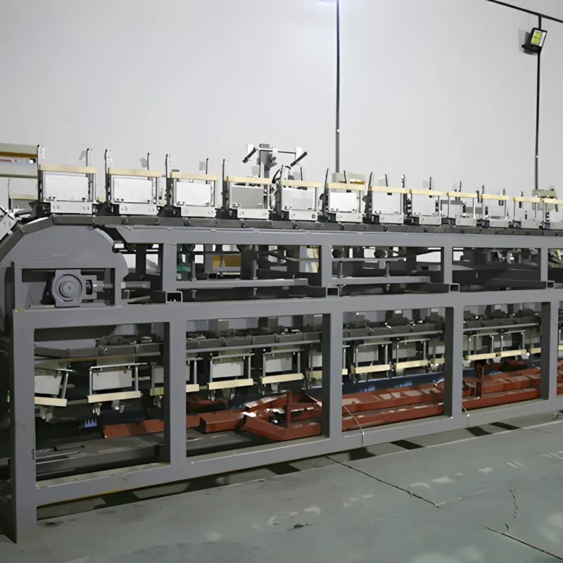 The image shows an automatic stripping machine used in a nitrile glove production line. The machine features several conveyor belts and mechanical components designed to automate the process of stripping nitrile gloves from their molds. The setup is in a factory environment, indicating an industrial setting for large-scale glove manufacturing.